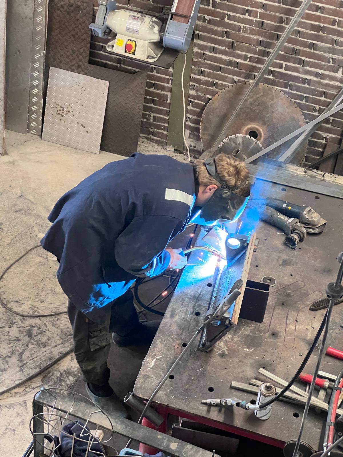 Welder working on metal fabrication